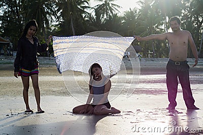 Asian girl tourists are having fun with the sea. Stock Photo