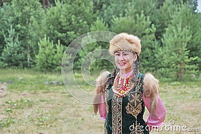 Asian girl in traditional festive Bashkir clothes at rural holiday. Stock Photo