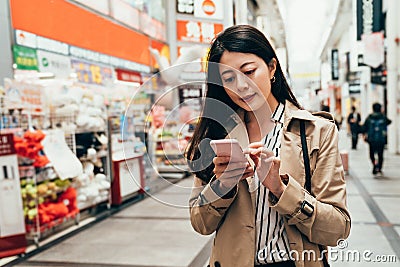 Asian girl using phone checking shopping list Stock Photo