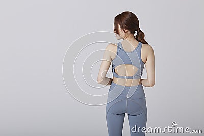 Asian girl wear exercise suit pose her back body in studio Stock Photo