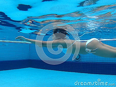 asian girl in white bikini daytime swim in pool Stock Photo