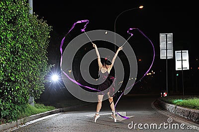 Asian girls dancing ballet on the road at night Stock Photo