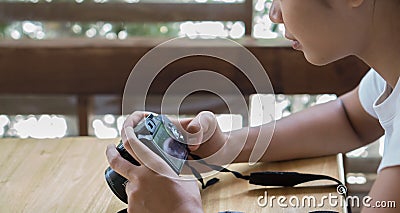 Asian girls are looking at photos taken from behind the camera. Stock Photo