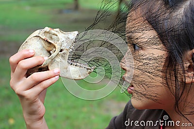 Asian girls with monkey bones. Stock Photo