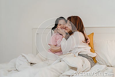 Asian grandmother read fairy tales to granddaughter at home. Senior Chinese, grandma happy relax with young girl enjoy good Stock Photo