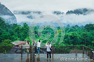 Asian group traveler in raining day VangVieng Editorial Stock Photo