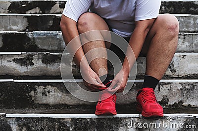 Asian Guy Tying Running Shoe, Preparing to Running for Losing Weight Stock Photo