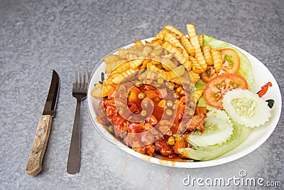 Asian Hainanese chicken chop with gravy and potato fries Stock Photo