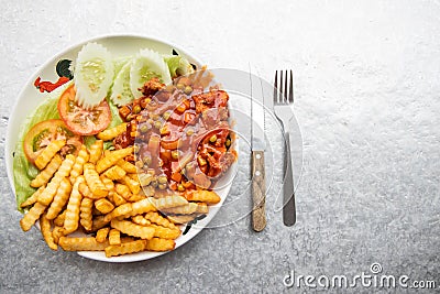 Asian Hainanese chicken chop with gravy and potato fries Stock Photo
