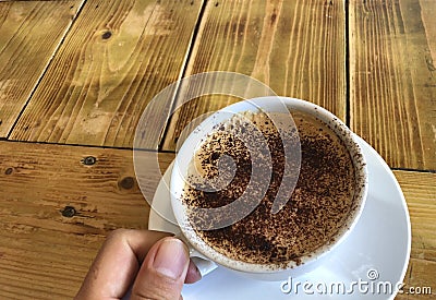 Asian hand holding cup of coffee Stock Photo