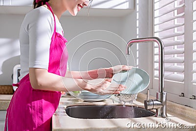 Asian housewife wash dishes Stock Photo