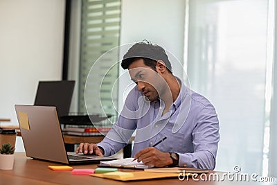 Asian indian business man talking with customer on mobile phone to get requirement and sale support Stock Photo
