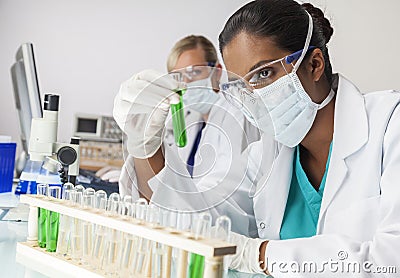 Asian Indian Female Laboratory Scientist Green Test Tube Stock Photo