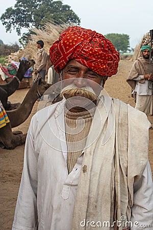 Asian Indian Man with Red Turban and Luxurious Mustache in Village Editorial Stock Photo