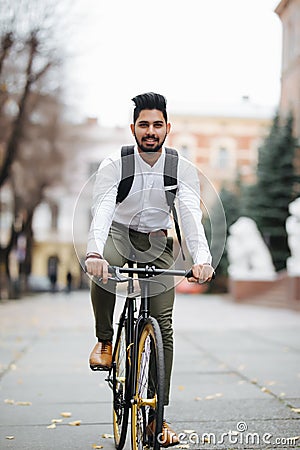 Asian indian riding bicycle in urban city street with speed and hipster trendy transportation Stock Photo