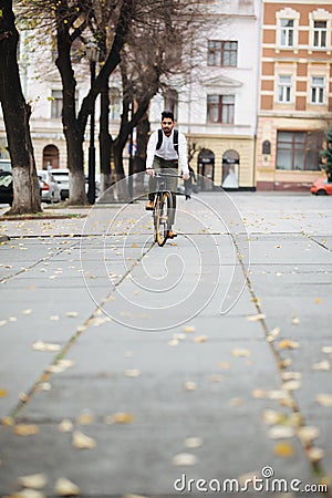 Asian indian riding bicycle in urban city street with speed and hipster trendy transportation Stock Photo