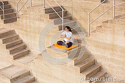 Asian Woman doing outdoor yoga tree pose meditation exercise, mental peace Fitness and health concept Editorial Stock Photo