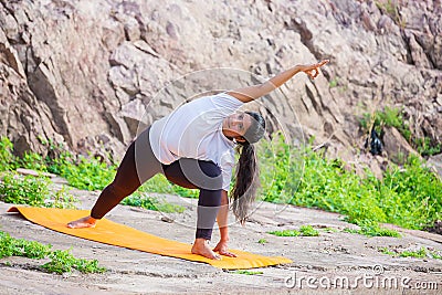 Asian, Indian Woman doing yoga stretching exercise outdoor, body Fitness and health concept Editorial Stock Photo