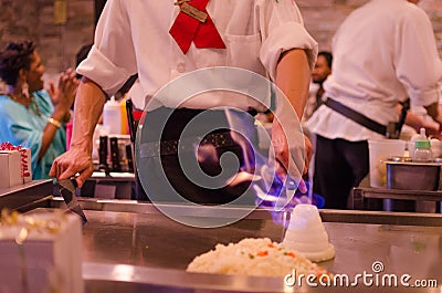 Hibachi restaurant chef preparing meal and entertaining guests Editorial Stock Photo