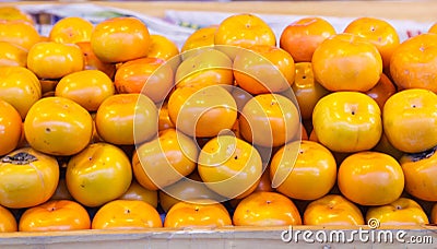 Asian or Japanese Persimmon Persimon fruits are sweet flavored with soft fibrous texture, not astringent when ripe. This ripened Stock Photo