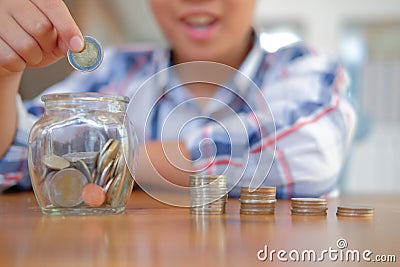 asian kid boy child children with coins stack jar. money savings Stock Photo