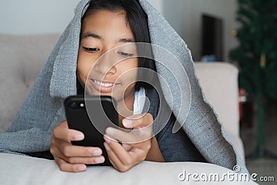 Asian kid girl are watching video that are joking on online media. The little girl using the smartphone to watch video for Stock Photo