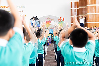 Asian kid stand in the line and exercise at outdoor Editorial Stock Photo