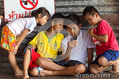 Asian kids watching smartphone screen Editorial Stock Photo