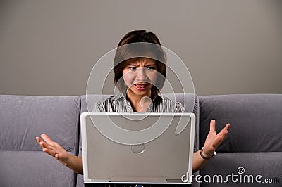 Asian lady in business attire, frustrated Stock Photo