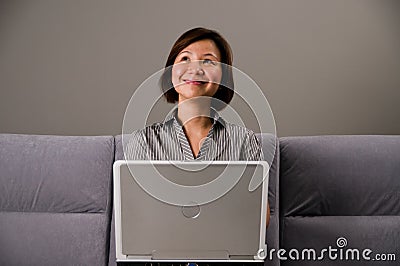 Asian lady in business attire, using a computer Stock Photo