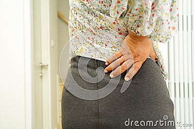 Asian lady patient wearing back pain support belt for orthopedic lumbar with walker Stock Photo