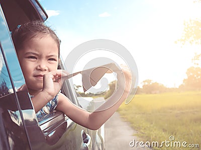 Asian little child girl having fun to play with paper airplane Stock Photo