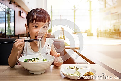 Asian little Chinese girl eating beef noodles soup Stock Photo