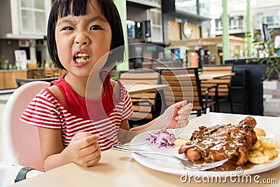 Asian Little Chinese Girl Eating Western Food Stock Photo