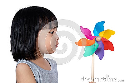 Asian Little Chinese Girl Playing Colorful Pinwheel Stock Photo