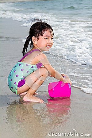 Asian Little Chinese Girl Playing Sand with Beach Toys Stock Photo