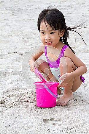 Asian Little Chinese Girl Playing Sand with Beach Toys Stock Photo