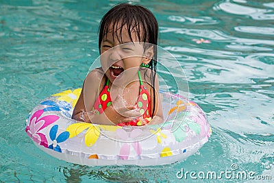 Asian Little Chinese Girl Playing in Swimming Pool Stock Photo