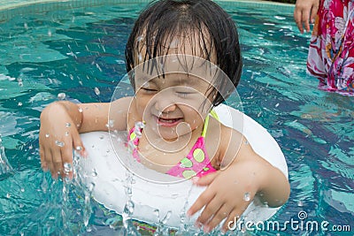 Asian Little Chinese Girl Playing in Swimming Pool Stock Photo