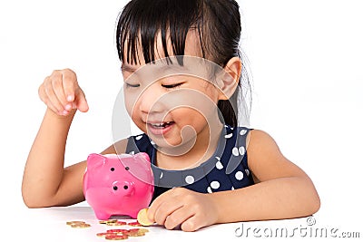 Asian Little Chinese Girl Putting Coins into Piggy Bank Stock Photo