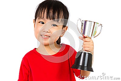 Asian Little Chinese Girl Smiles with a Trophy in Her Hands Stock Photo