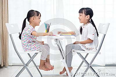 Asian Little Chinese sisters doing homework Stock Photo