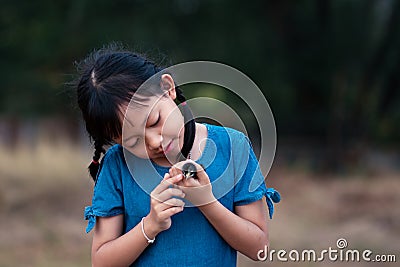 Asian little gilr holding a chick in her hand with love and happy Stock Photo