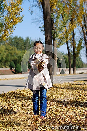 Asian little girl in autumn Stock Photo