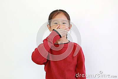 Asian little girl covering mouth with hand on white isolated background. Kid have a Secret concept Stock Photo