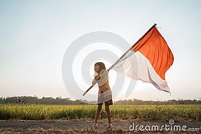 Asian little girl flapping Indonesian flag Stock Photo
