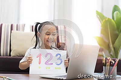 Asian little girl show homework learning using laptop computer virtual internet online Stock Photo