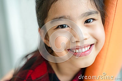 Asian little girl smiling with perfect smile and white teeth in dental care Stock Photo