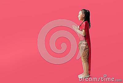 Asian little girl in Thai national costumes with welcome gesture of hands of Thailand Stock Photo