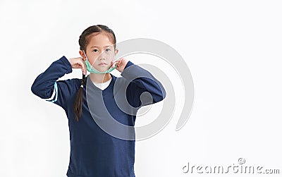 Asian little kid girl wearing medical face mask slung on her chin isolated on white background. Amid covid-19 pandemic concept Stock Photo